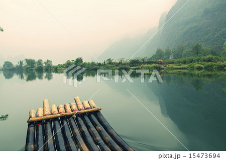 China Guilin Yangshuo bamboo rafting in the beautiful "Yulong River". 15473694