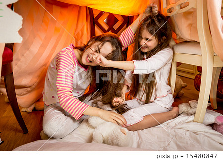 Two young sisters having a fight in bedroom Two young sisters having a fight in bedroom 15480847