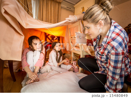 mother looking at two girls playing at bedroom in house made of mother looking at two girls playing at bedroom in house made of 15480849