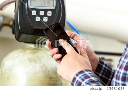 man typing factory equipment meter reading at smartphone 15481053