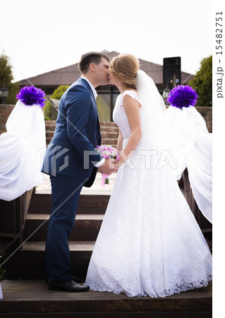 married couple standing face to face and kissing 15482751