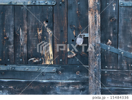 Old rustic faded wood gate with a lock 15484336