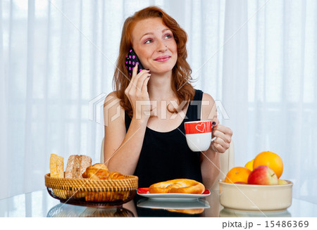 attractive girl with freckles eating breakfast attractive girl with freckles eating breakfast 15486369