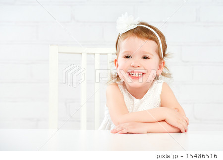 Happy fun funny girl child laughing at  empty white table 15486516