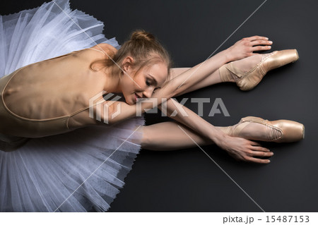 Graceful ballerina sitting on the floor Graceful ballerina sitting on the floor 15487153