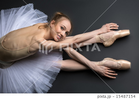 Graceful ballerina sitting on the floor Graceful ballerina sitting on the floor 15487154