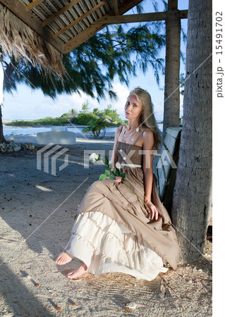 young woman in a long sundress on a tropical beach 15491702