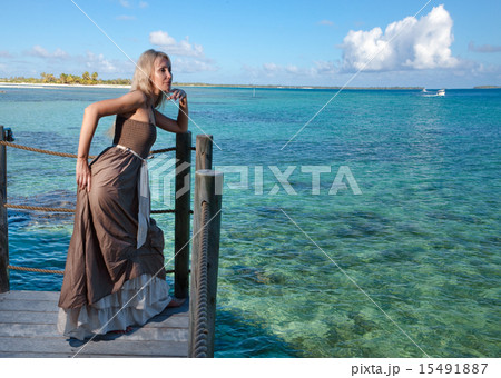 beautiful woman on a wooden scaffold over the sea 15491887