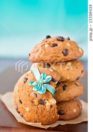 Stacked chocolate chip cookies with blue ribbon 15506439
