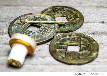 acupuncture needle on chinese coins 15508630
