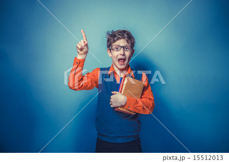 European-looking  boy of ten years in glasses thumbs up, the ide 15512013