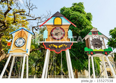 A clock house and swing in park 15527538
