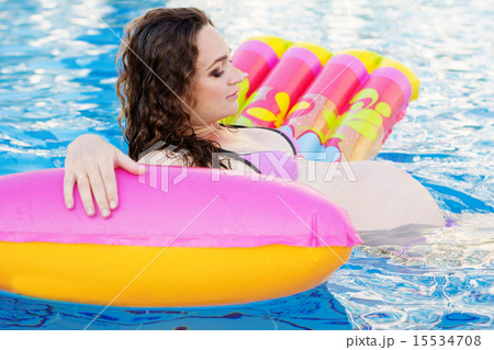 Pregnant pretty girl is swimming in pool Pregnant pretty girl is swimming in pool 15534708