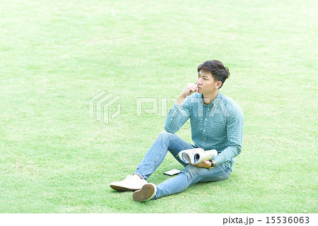 Chinese student studying on grass field 15536063