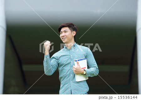 Chinese student with textbook celebrate success 15536144