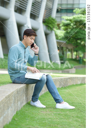 Chinese student making a call while studying Chinese student making a call while studying 15536192