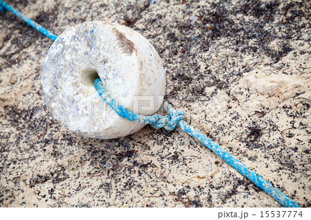 Old fishing net fragment with white float and rope Old fishing net fragment with white float and rope 15537774