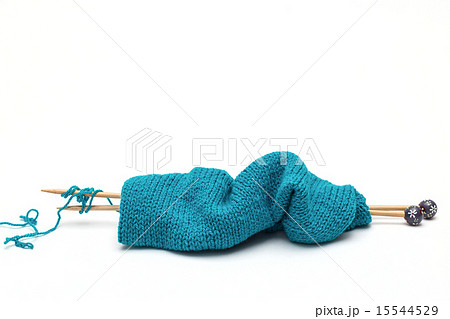 blue yarn with knitted fabric and knitting needles 15544529