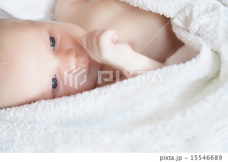 newborn tiny baby lying on the bed side view 15546689