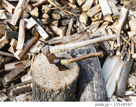 pile of wood, deck for chopping firewood, two axes 15548567