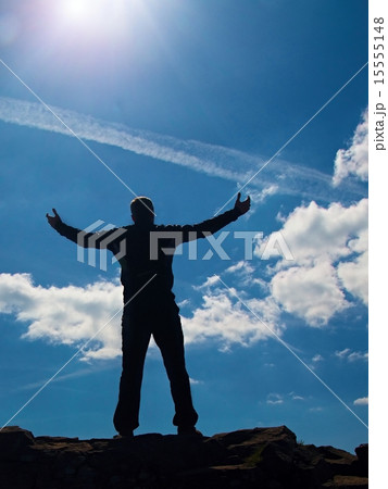 Hiker in black gesture of triumph. Tourist on rock Hiker in black gesture of triumph. Tourist on rock 15555148