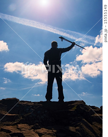 Hiker in black gesture of triumph. Tourist on rock Hiker in black gesture of triumph. Tourist on rock 15555149