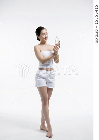 Beautiful woman cares of the skin face isolated on white background Beautiful woman cares of the skin face isolated on white background 15556415