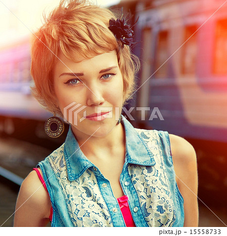 Young lovely girl at the train station 15558733