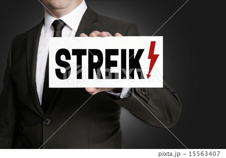 Strike sign is held by businessman 15563407