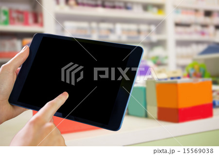 Composite image of man using tablet pc Composite image of man using tablet pc 15569038