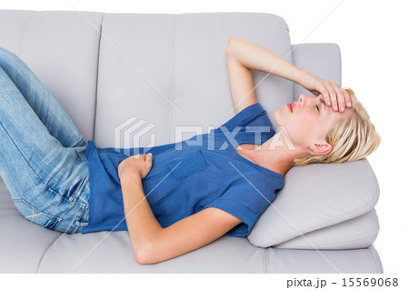 Attractive blonde woman having headache on the couch Attractive blonde woman having headache on the couch 15569068