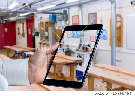 Composite image of man using tablet pc 15569464