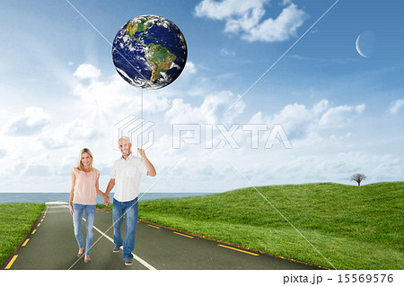 Composite image of happy couple walking holding hands Composite image of happy couple walking holding hands 15569576
