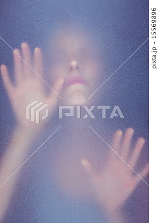Blonde woman touching frosted glass 15569896
