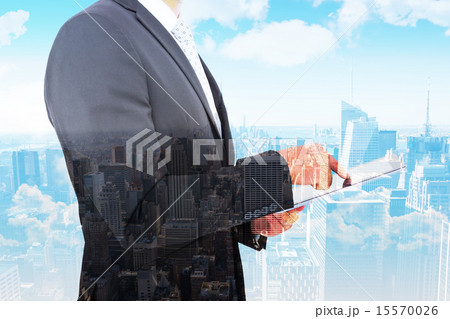 Composite image of businessman using his tablet pc Composite image of businessman using his tablet pc 15570026