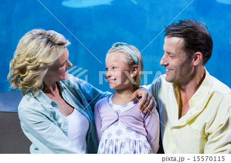 Happy family standing beside the fish tank Happy family standing beside the fish tank 15570115