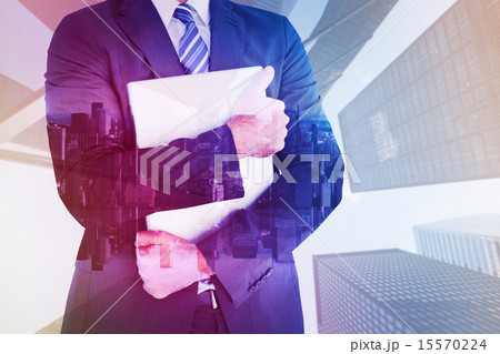 Composite image of businessman holding his laptop tightly Composite image of businessman holding his laptop tightly 15570224