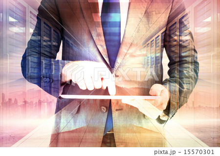 Composite image of businessman using his tablet pc 15570301