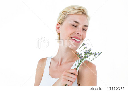 Gorgeous blonde woman smelling flowers Gorgeous blonde woman smelling flowers 15570375