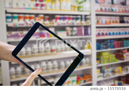 Composite image of finger pointing to tablet Composite image of finger pointing to tablet 15570550