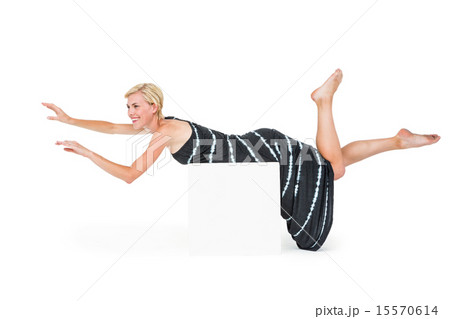 Attractive blonde woman lying on white block 15570614