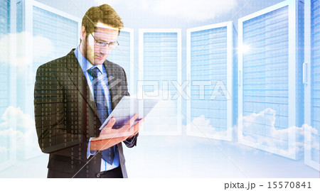 Composite image of businessman using a tablet computer Composite image of businessman using a tablet computer 15570841