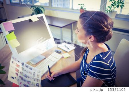 Happy editor working at her desk 15571105