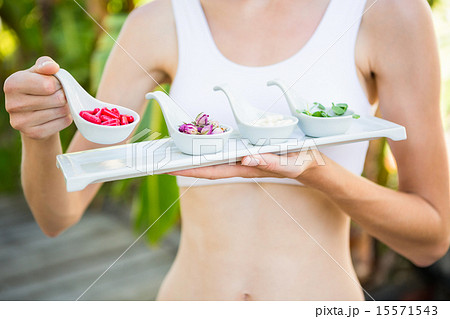 Fit woman holding plate with herbal medicine 15571543