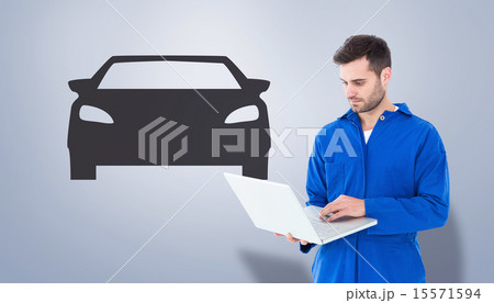 Composite image of male mechanic using laptop 15571594