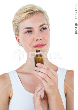 Gorgeous blonde woman smelling bottle of medicine Gorgeous blonde woman smelling bottle of medicine 15571689