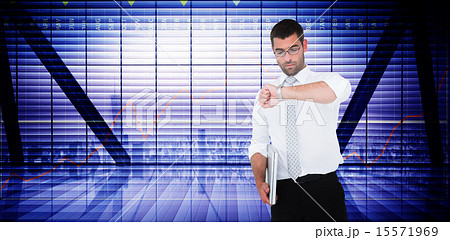 Composite image of serious businessman holding laptop checking t 15571969