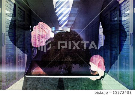 Composite image of businessman looking at tablet with magnifying 15572483