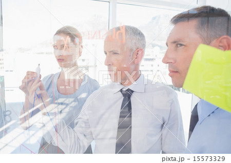 Businessman drawing graph on the glass Businessman drawing graph on the glass 15573329