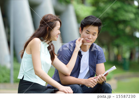 Chinese couple pinching cheeks 15587230